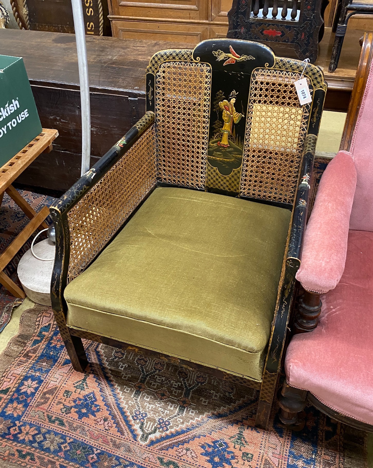 A 1920's Chinoiserie lacquer bergere armchair, width 64cm, depth 65cm, height 85cm